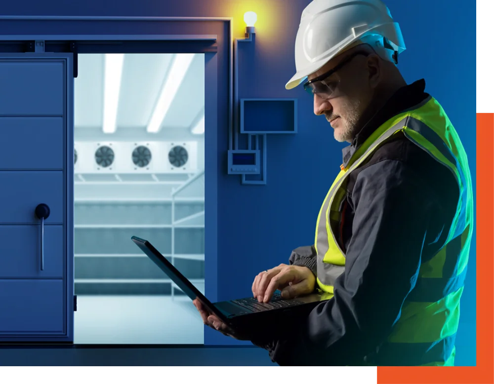 temperatura Un uomo con casco e giubbotto di sicurezza utilizza un laptop in un ambiente di lavoro.